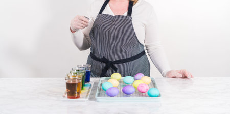 Easter egg coloring. Dye white organic eggs in different colors for Easter.