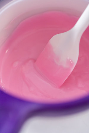 Melting chocolate melts in a candy melting pot to prepare hot chocolate bombs.の写真素材