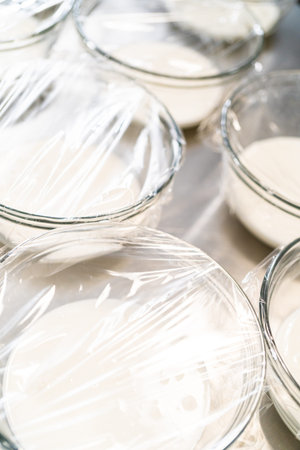 Mixing ingredients in a large glass mixing bowl to make homemade royal icing.