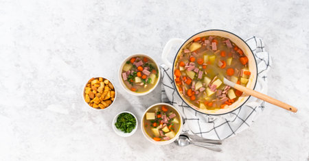 Flat lay. Serving split pea soup in ceramic soup bowls.