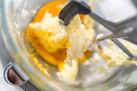 Lemon Cookies with White Chocolate. Mixing ingredients in kitchen mixer to bake lemon cookies with...