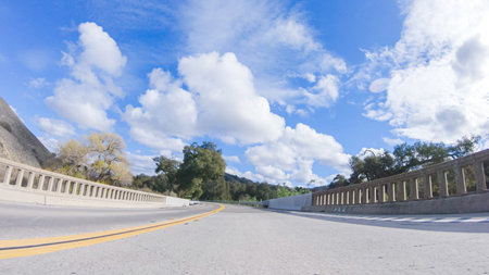 Vehicle is cruising along the Cuyama Highway under the bright sun. The surrounding landscape is...