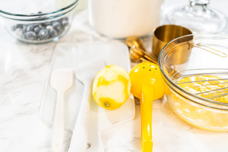 Integrating ingredients in a glass bowl, adeptly stirring with a whisk to craft a tantalizing...