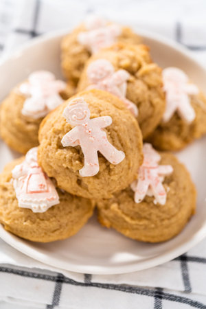 Eggnog cookies with a chocolate gingerbread man on a white plate.