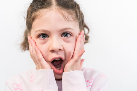 Little girl with rainbow braces with a surprised face.の写真素材