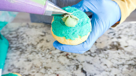 Using buttercream frosting, vanilla and chocolate cupcakes are intricately decorated to resemble...