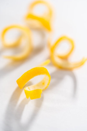 Preparing lemon swirls from the organic lemon to decorate the cocktail.の写真素材