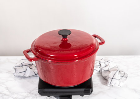 Boiling pasta in an enameled dutch oven to prepare chicken alfredo pasta.の写真素材