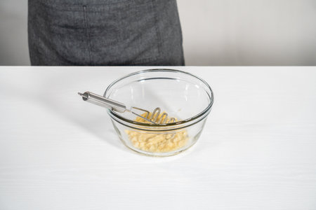 Mashed overripe banana in a glass mixing bowl.の写真素材