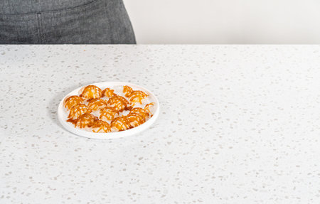 Crunchy caramel cupcake toppers on the counter.