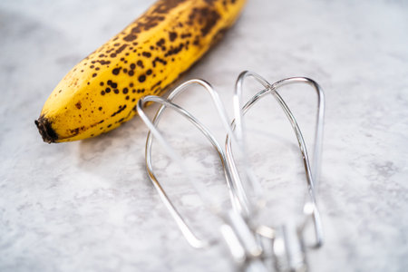 Mashing overhyped banana with an electric hand mixer.