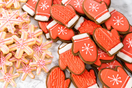 Many Christmas gingerbread cookies with royal icing.