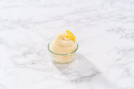 Swirl lemon buttercream frosting in a small glass bowl.の写真素材