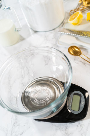 Skillfully combine ingredients using a hand mixer to prepare a rich, smooth cream cheese buttercream frosting, which is perfect for adorning the bundt cake.の写真素材
