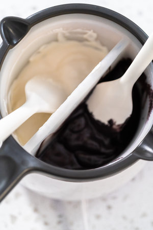Melting chocolate chips in a candy melting pot to make Halloween chocolate-covered pretzel rods.の写真素材