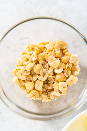 Measured ingredients in glass mixing bowls to prepare chocolate hazelnut fudge.の写真素材