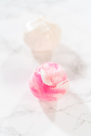 Artfully adorning the vanilla and chocolate cupcakes with delicate fondant pieces transforms them into festive treats suitable for a birthday celebration.の写真素材