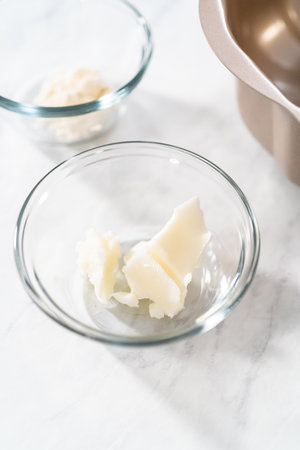 Greasing metal bundt cake pan with vegetable shortening and flour to bake lemon blueberry bundt cake.の写真素材
