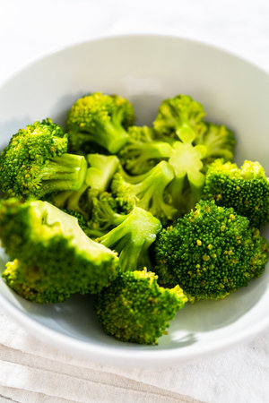 Freshly steamed broccoli in a white bowl.の写真素材