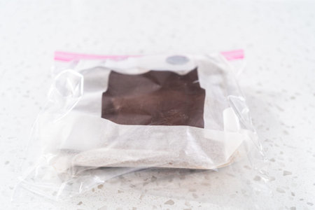Storing plain homemade fudge into the reusable plastic bag.
