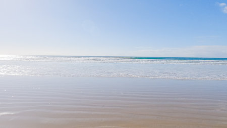 Pismo Beach is strikingly empty during a winter day, offering a serene and peaceful atmosphere with its expansive sandy shore and the soothing sounds of the waves.の写真素材