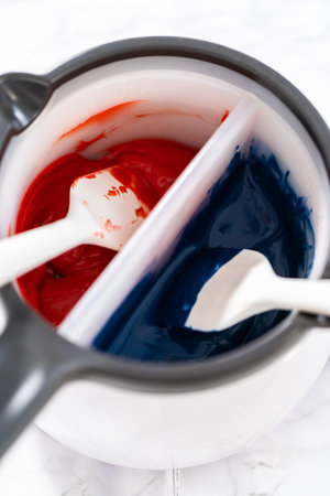 Melting chocolate chips in a candy melting pot to make chocolate stars for patriotic lemon cupcakes.の写真素材