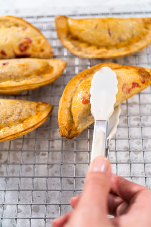 Freshly baked sweet cherry empanadas in the air fryer on the kitchen counter.