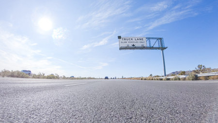 Embarking on a road trip from Nevada to California, driving on Highway 15 during the day offers scenic views and an exciting journey between states.の写真素材