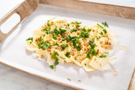 Spreading unsalted butter at room temperature to prepare a vegetarian party butter board for a...