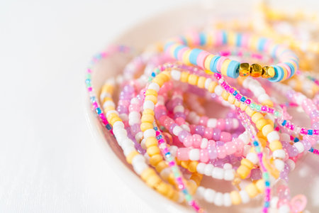 Little girls charming bracelets adorned with clay and sea beads.