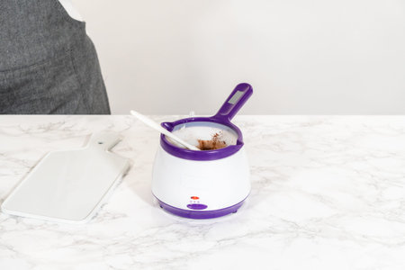 Melting vegetable shortening and cocoa powder in the candy melting pot creates a perfect mixture for...