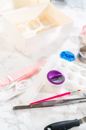 Artfully adorning the vanilla and chocolate cupcakes with delicate fondant pieces transforms them...
