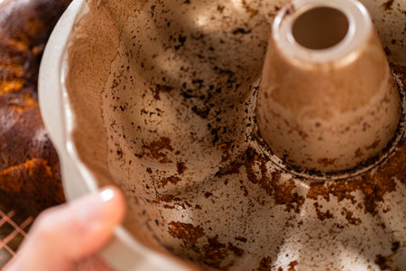 A close-up view of a dirty bundt cake pan after baking.の写真素材