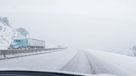POV-Electric vehicle is captured deftly navigating the I-70 highway during a winter storm in Western Colorado.の写真素材