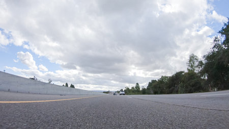 On a cloudy winter day, a car smoothly travels along Highway 101 near Santa Maria, California, under...