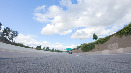 On a clear winter day, a car smoothly travels along Highway 101 near Santa Maria, California, under...
