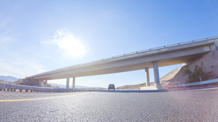 Embarking on a road trip from Nevada to California, driving on Highway 15 during the day offers scenic views and an exciting journey between states.の写真素材