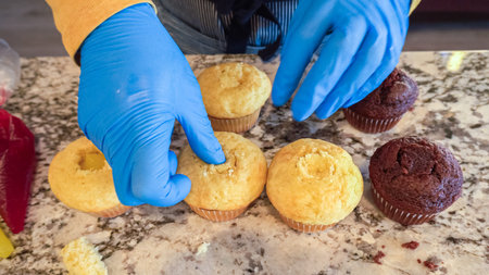 In the process of crafting delightful cactus cupcakes, the freshly baked vanilla and chocolate cupcakes are generously filled with tangy lemon and sweet raspberry filling, enhancing the flavors and creating a delectable surprise for the palate.の写真素材