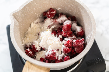 In a small saucepan, the measured ingredients come together - allowing the delicious Raspberry Cake Filling to simmer and infuse with delightful flavors.の写真素材