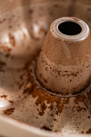 A close-up view of a dirty bundt cake pan after baking.の写真素材
