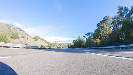 On a crisp winter day, a car cruises along the iconic Highway 1 near San Luis Obispo, California....