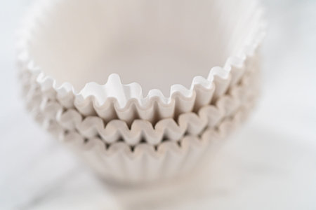 New white paper cupcake liners on the kitchen counter.