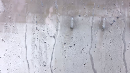 Soapy windshield view from inside a car during an automatic wash cycle, with the foam obscuring the...