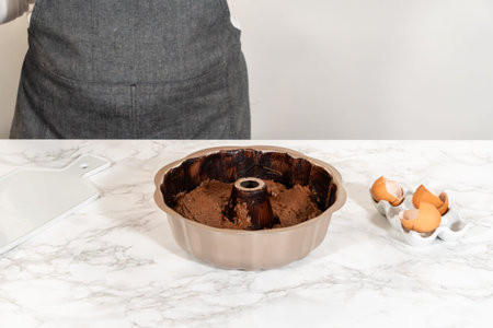The prepared batter is carefully filled into the greased bundt pan - setting the stage for a...