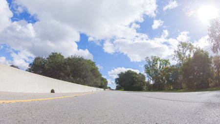 On a clear winter day, a car smoothly travels along Highway 101 near Santa Maria, California, under...