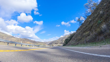 Vehicle is cruising along the Cuyama Highway under the bright sun. The surrounding landscape is...