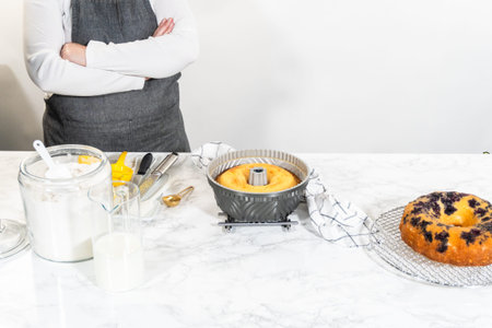Allowing the freshly baked bundt cake to gradually cool down prior to extracting it from the pan is an essential step in the process.の写真素材