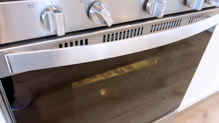 Crispy bacon strips bake evenly on a parchment-lined tray inside an oven, showcasing a clean and efficient method for achieving perfectly cooked bacon with minimal mess.の写真素材