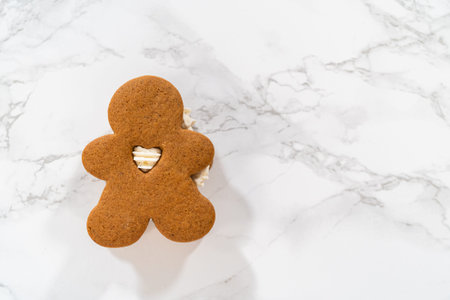 Gingerbread cookies filled with eggnog buttercream stand out, their rich hue complementing the...