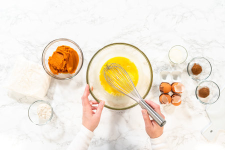 Flat lay. In a cozy kitchen, a large mixing bowl becomes the stage for expertly blending the...